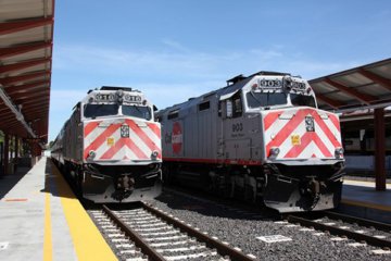 Two trains on tracks at Caltrain station