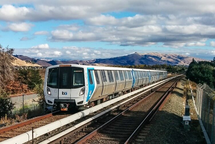 BART train travelling on tracks in the Bay Area