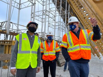 Authority CEO Brian Kelly shows the site of the Cedar Viaduct to USDOT FRA Deputy Administrator Amit Bose, this photo shows them both beneath one of the viaduct's arches, the CEO's hand outstretched explaining the structure.