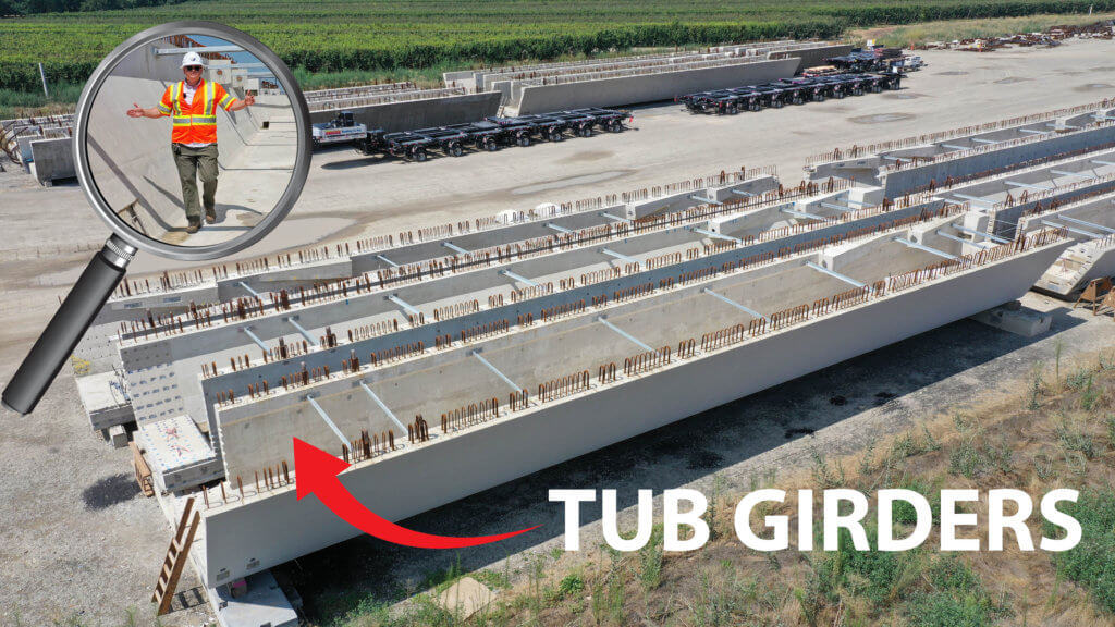 Rows of tub girders laying on a road. The girders are large and long concrete structure pieces with metal work sticking out. At the bottom left of the image is the words "Tub Girder" and a red arrow pointing to one of the tub girders. In the top left is an artistic representation of a magnifying glass showing a man in a safety vest, construction hat, and green paints walking inside a tub girder.