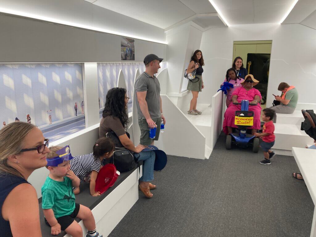 Public standing in train mockup at California Fair.